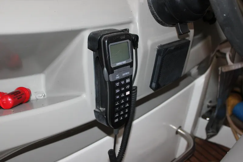 Slide: The Image of Control panel of 2012 Beneteau Gran Turismo 38 with marine radio and safety equipment. - 14