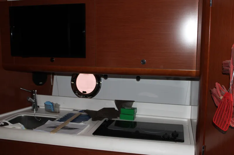 Slide: The Image of Interior of 2012 Beneteau Gran Turismo 38 yacht kitchen with sink and stove. - 15