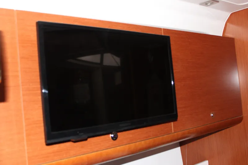 Slide: The Image of Flat-screen TV on 2012 Beneteau Gran Turismo 38 yacht's wooden interior. - 18