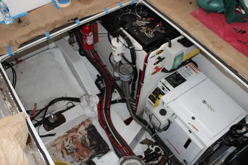 Slide: The Image of Engine compartment of a 2012 Beneteau Gran Turismo 38, featuring mechanical components and wiring. - 26