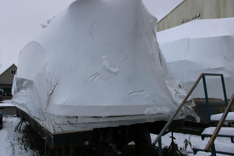 Slide: The Image of 2012 Beneteau Gran Turismo 38 yacht covered in snow, stored outdoors. - 3