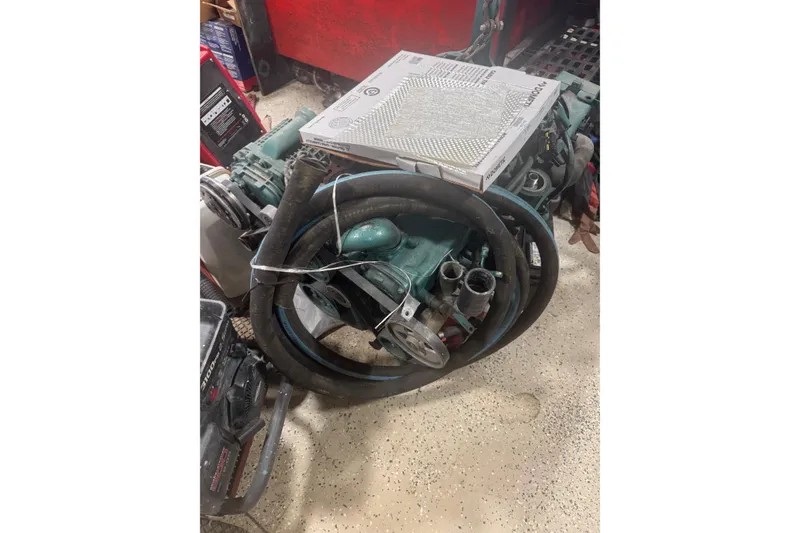 Slide: The Image of 2012 Beneteau Gran Turismo 38 engine with hoses and parts in a workshop. - 30