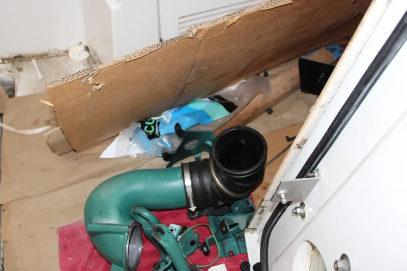 Slide: The Image of Engine compartment of a 2012 Beneteau Gran Turismo 38 with visible components and tools. - 32