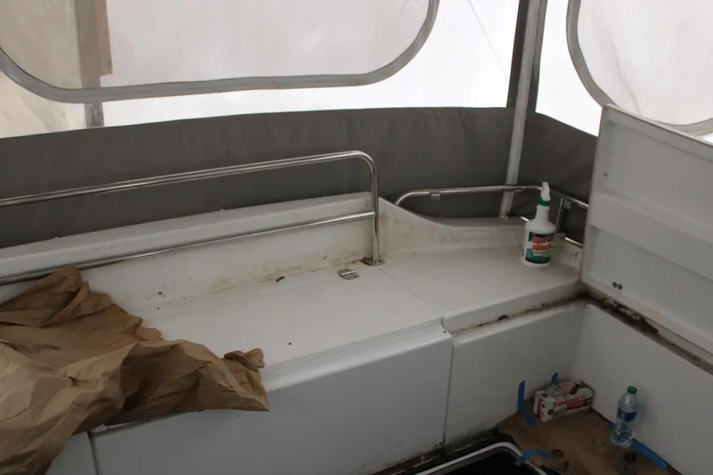 Slide: The Image of Interior of 2012 Beneteau Gran Turismo 38 showing seating area with cleaning supplies. - 6