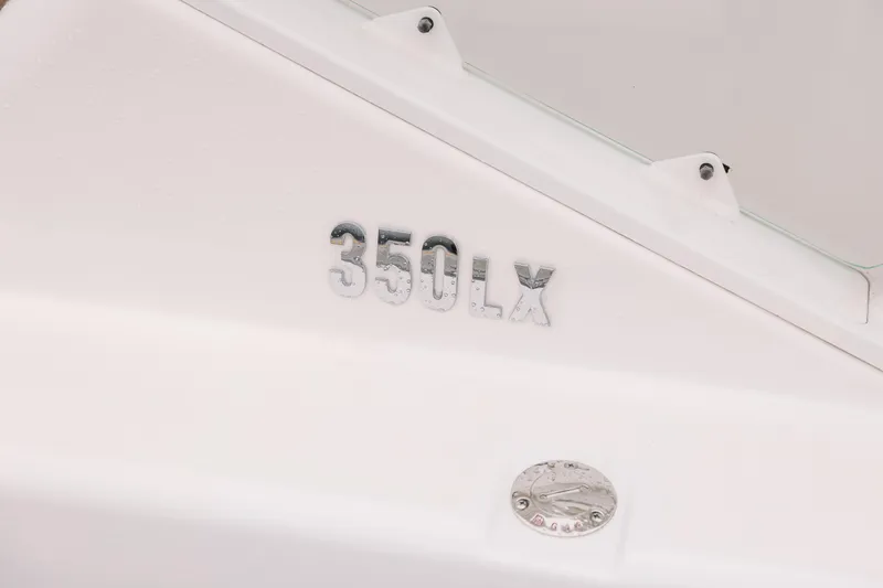 Slide: The Image of Close-up of 2010 Everglades 350LX boat model nameplate on white surface. - 10