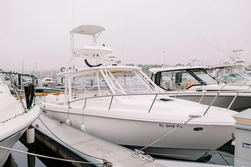 Slide: The Image of 2010 Everglades 350LX boat docked at marina on a foggy day. - 2