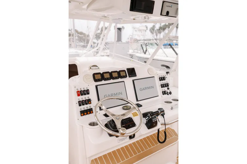 Slide: The Image of Cockpit of 2010 Everglades 350LX boat with Garmin navigation system and controls. - 22