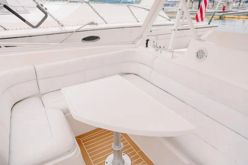 Slide: The Image of Luxurious seating area on 2010 Everglades 350LX boat with white upholstery and table. - 25