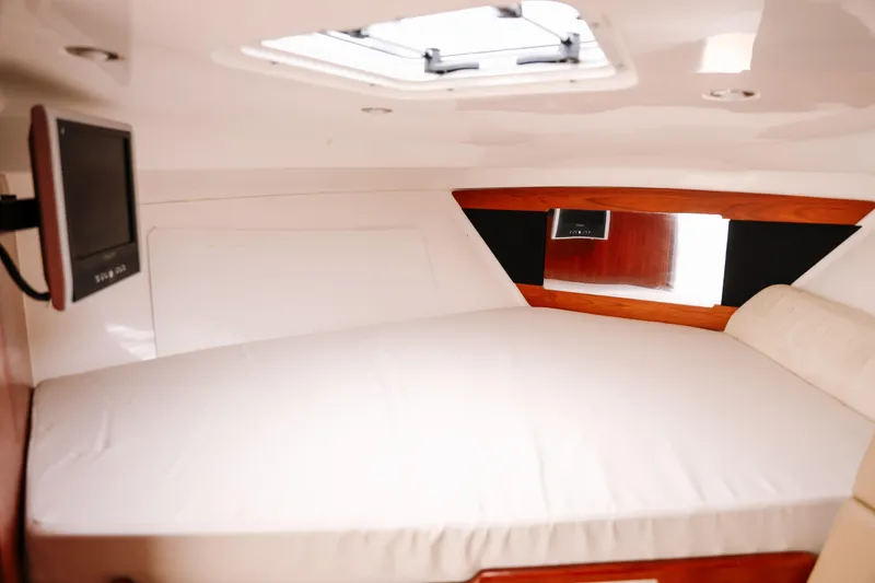 Slide: The Image of Interior cabin of 2010 Everglades 350LX boat with bed and window. - 27
