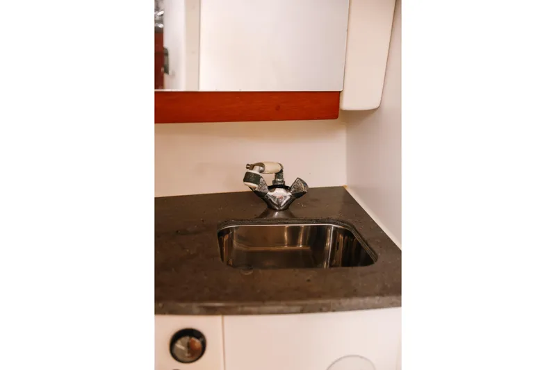 Slide: The Image of 2010 Everglades 350LX boat interior sink with chrome faucet and countertop. - 28