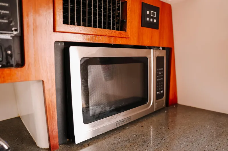 Slide: The Image of Built-in microwave in 2010 Everglades 350LX boat kitchen area. - 32
