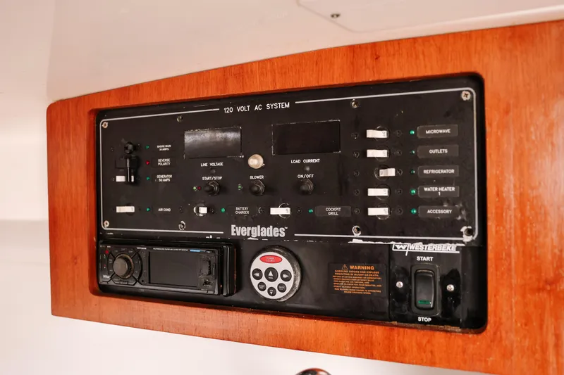 Slide: The Image of Control panel of a 2010 Everglades 350LX boat, featuring various switches and indicators. - 33