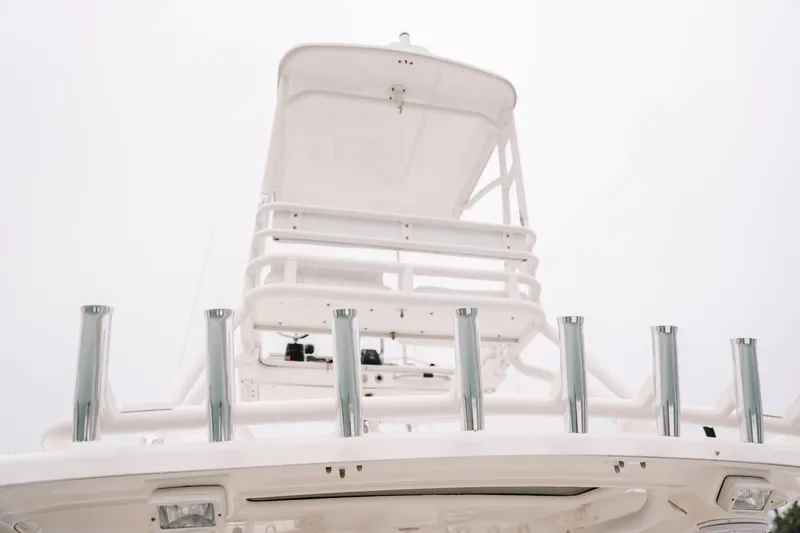 Slide: The Image of 2010 Everglades 350LX boat tower with rod holders against a cloudy sky. - 7