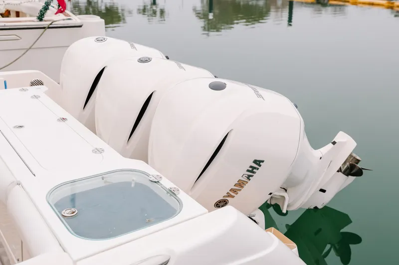 Slide: The Image of Triple Yamaha outboard engines on a 2010 Everglades 350LX boat at a marina. - 9