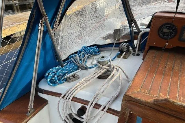 Slide: The Image of 1986 Tayana 37 sailboat cockpit with ropes, winch, and blue canopy. - 10