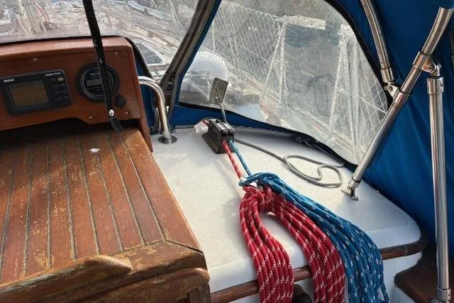 Slide: The Image of 1986 Tayana 37 sailboat cockpit with ropes and navigation equipment. - 11