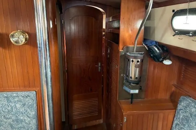 Slide: The Image of Interior of 1986 Tayana 37 sailboat with wooden paneling and nautical decor. - 17