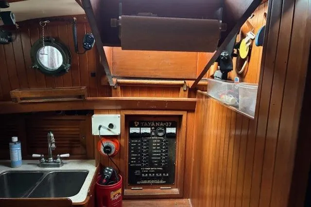 Slide: The Image of Interior of 1986 Tayana 37 sailboat with wooden paneling and control panel. - 23
