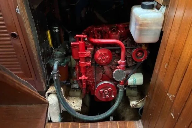 Slide: The Image of Engine compartment of a 1986 Tayana 37 sailboat with a red engine. - 26