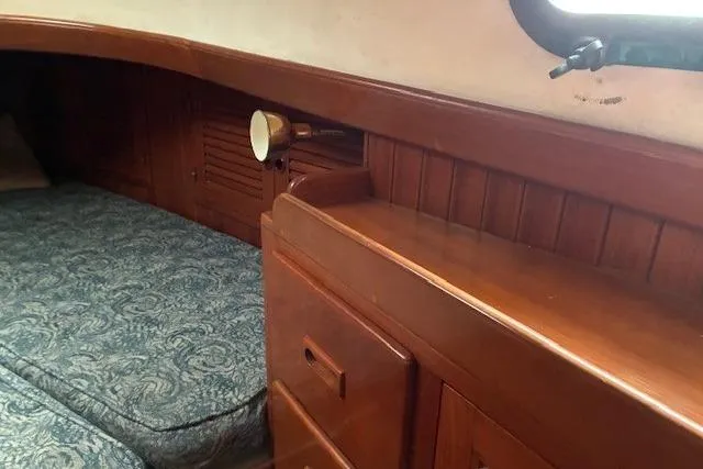 Slide: The Image of Cozy cabin interior of 1986 Tayana 37 sailboat with wooden furnishings and bed. - 31