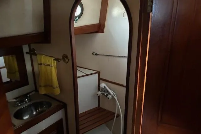 Slide: The Image of 1986 Tayana 37 yacht bathroom with sink, shower, and yellow towel. - 33