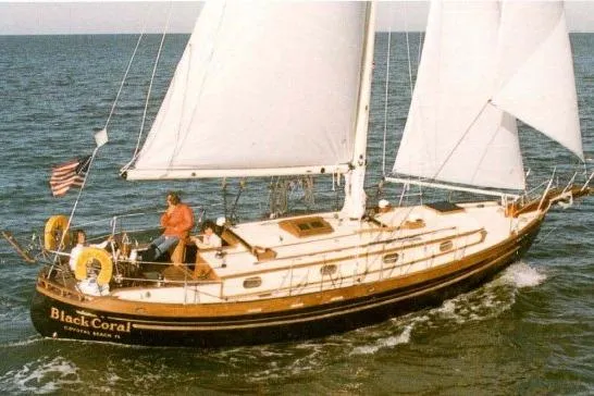 Slide: The Image of 1986 Tayana 37 sailboat "Black Coral" sailing on open water. - 34