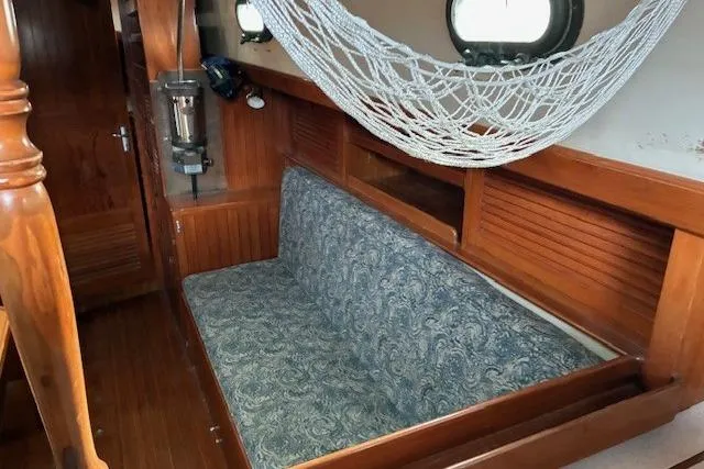 Slide: The Image of Interior of 1986 Tayana 37 sailboat with wooden finish and hammock. - 4