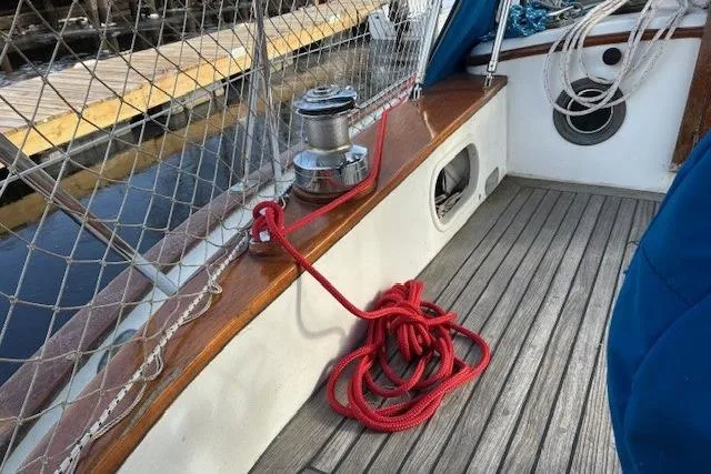 Slide: The Image of 1986 Tayana 37 sailboat deck with red rope and winch. - 5