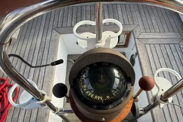 Slide: The Image of Compass on 1986 Tayana 37 sailboat, wooden deck, nautical navigation equipment. - 7