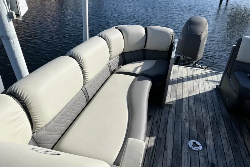Slide: The Image of 2022 Veranda VP 25RC pontoon boat with luxurious seating on a wooden deck. - 10