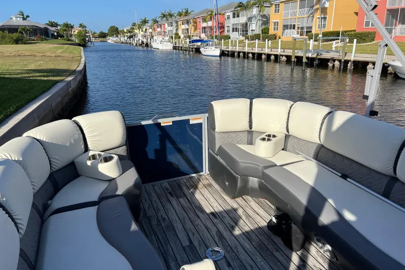 Slide: The Image of 2022 Veranda VP 25RC pontoon boat with luxurious seating on a scenic canal. - 7