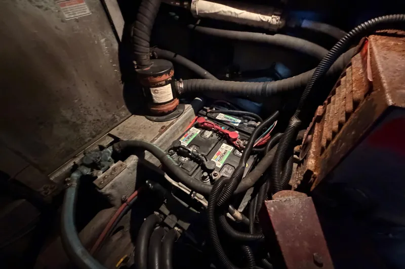 Slide: The Image of Engine compartment of a 1997 Sea Ray 370 Aft Cabin with visible battery and wiring. - 105