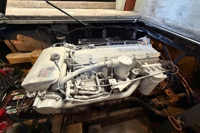 Slide: The Image of Engine compartment of a 1997 Sea Ray 370 Aft Cabin boat, showcasing detailed machinery. - 106