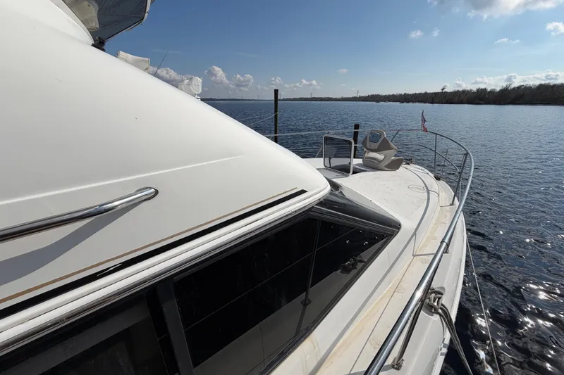 Slide: The Image of 1997 Sea Ray 370 Aft Cabin yacht on calm water under a clear sky. - 14