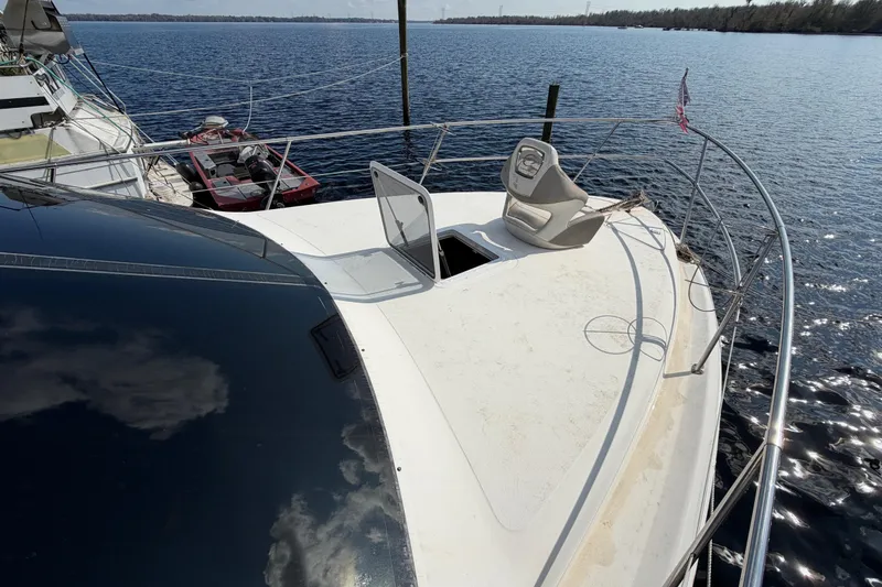 Slide: The Image of 1997 Sea Ray 370 Aft Cabin yacht on calm water, featuring spacious deck and seating. - 15