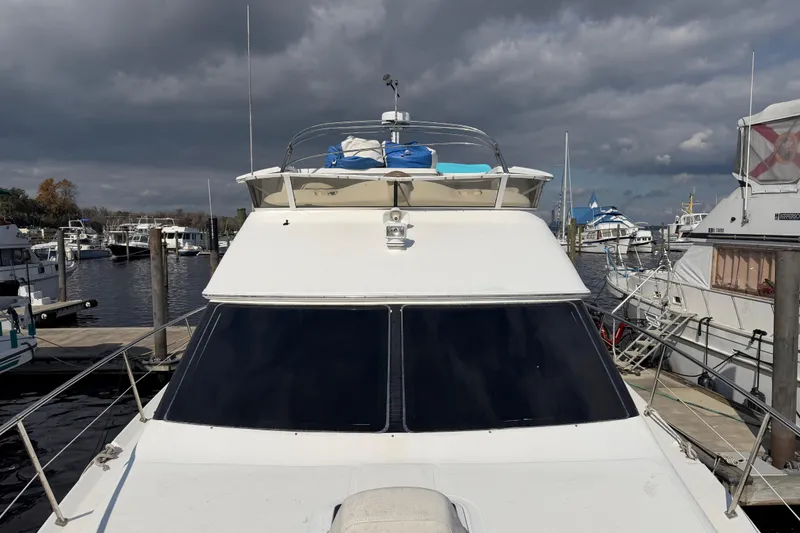 Slide: The Image of 1997 Sea Ray 370 Aft Cabin yacht docked at marina under cloudy skies. - 19