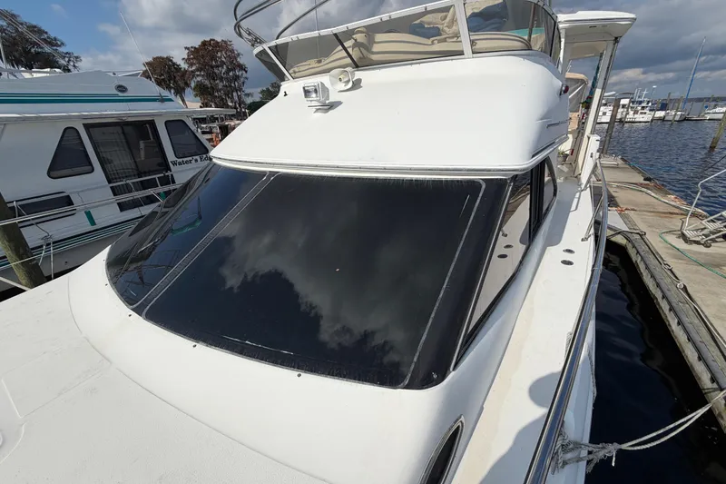 Slide: The Image of 1997 Sea Ray 370 Aft Cabin yacht docked at marina under cloudy sky. - 23