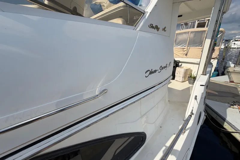 Slide: The Image of 1997 Sea Ray 370 Aft Cabin yacht docked at marina, side view. - 24