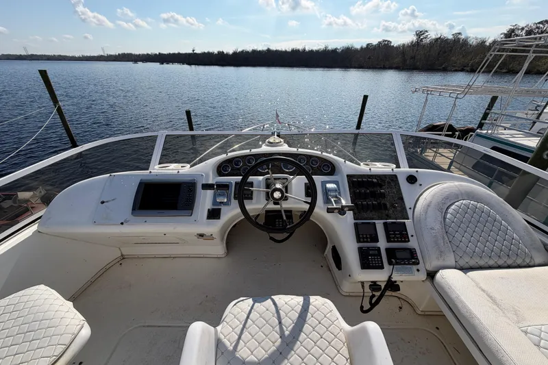 Slide: The Image of Cockpit view of 1997 Sea Ray 370 Aft Cabin yacht with steering wheel and controls. - 26