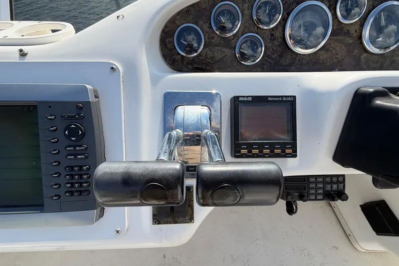 Slide: The Image of 1997 Sea Ray 370 Aft Cabin helm with gauges and navigation controls. - 29