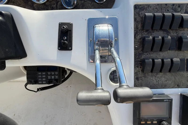 Slide: The Image of Control panel of a 1997 Sea Ray 370 Aft Cabin boat with throttle levers and switches. - 33