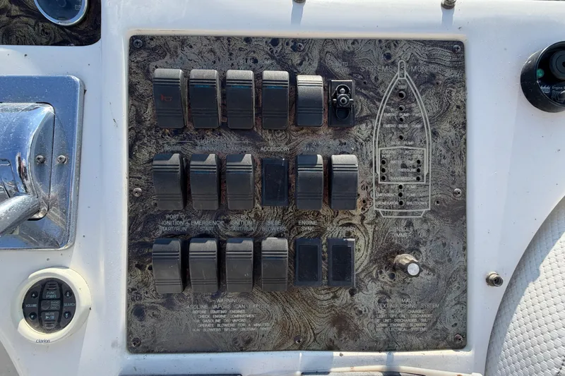 Slide: The Image of Control panel of a 1997 Sea Ray 370 Aft Cabin boat with various switches and indicators. - 34