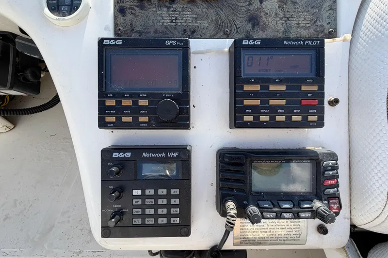Slide: The Image of Control panel of a 1997 Sea Ray 370 Aft Cabin with navigation and communication devices. - 35