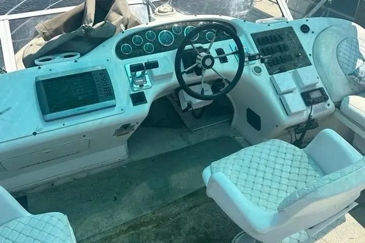 Slide: The Image of 1997 Sea Ray 370 Aft Cabin yacht docked at marina under blue sky. - 4