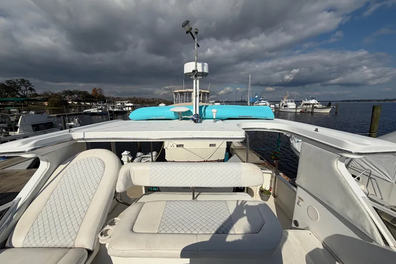 Slide: The Image of 1997 Sea Ray 370 Aft Cabin yacht docked at marina under cloudy sky. - 40