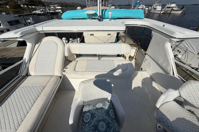 Slide: The Image of 1997 Sea Ray 370 Aft Cabin boat interior with white seating and marina view. - 41