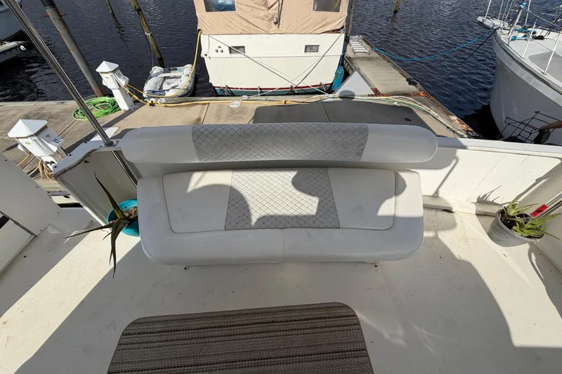Slide: The Image of 1997 Sea Ray 370 Aft Cabin boat with cushioned seating on deck at marina. - 48