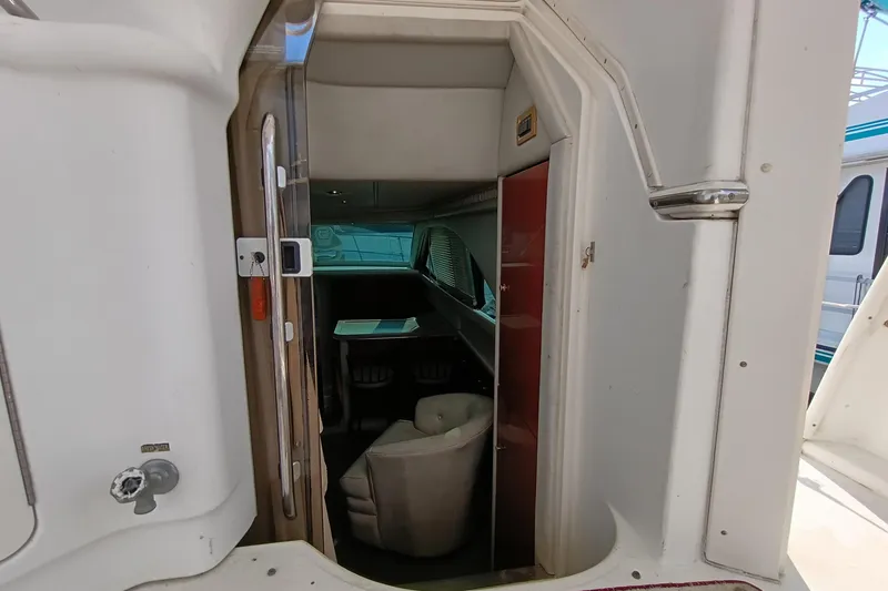 Slide: The Image of 1997 Sea Ray 370 Aft Cabin interior view with seating and table. - 49