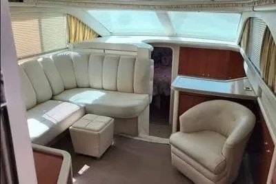 Slide: The Image of 1997 Sea Ray 370 Aft Cabin yacht docked under a cloudy sky. - 5