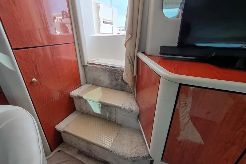 Slide: The Image of Interior stairs of 1997 Sea Ray 370 Aft Cabin with wooden cabinetry. - 54